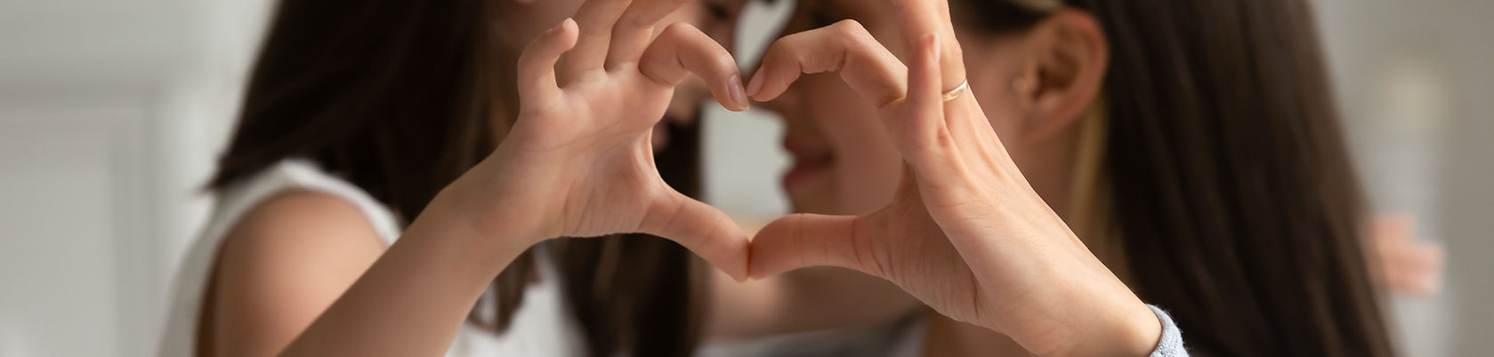 Mom and Child forming Heart with hands